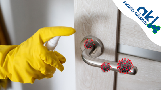 Yellow gloved hand sanitizing door handle
