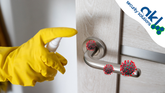  Yellow gloved hand sanitizing door handle
